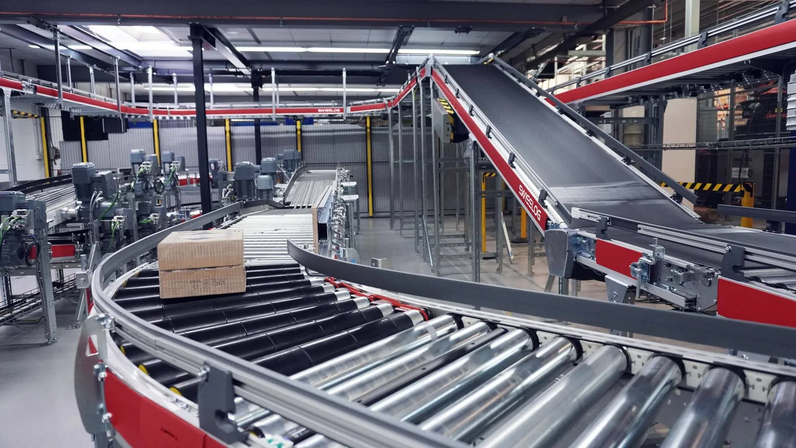 Automated sortation system routing items along conveyors to the correct chutes and destinations